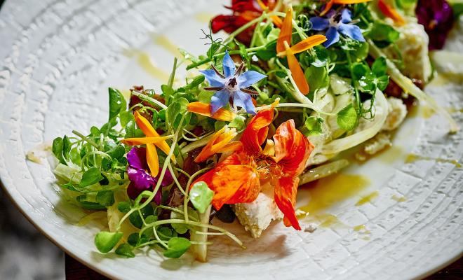 plate of food decorated with edible flowers