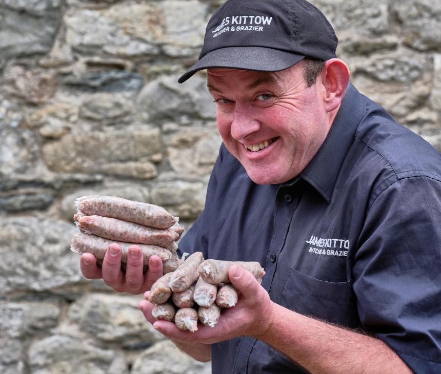 James Kittow_butcher_holding sausages